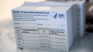 FILE - A stack of COVID-19 Vaccination Record Cards from the CDC.