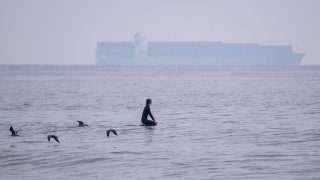 a large container ship sitting off the coast