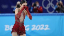 Zhu Yi of China reacts after the figure skating team event