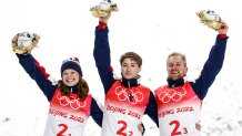 Team USA's Ashley Caldwell, Christopher Lillis and Justin Schoenefeld celebrate gold after the mixed team aerial skiing event at the Genting Snow Park as part of the 2022 Winter Olympic Games.