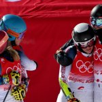 Team USA's Paula Moltzan (2ndR), USA's Tommy Ford (R), USA's Mikaela Shiffrin (L) and USA's River Radamus react after the Mixed Team Parallel bronze final during the 2022 Winter Olympics at the Yanqing National Alpine Skiing Centre in Yanqing, China on Feb. 20, 2022.