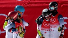 Team USA's Paula Moltzan (2ndR), USA's Tommy Ford (R), USA's Mikaela Shiffrin (L) and USA's River Radamus react after the Mixed Team Parallel bronze final during the 2022 Winter Olympics at the Yanqing National Alpine Skiing Centre in Yanqing, China on Feb. 20, 2022.