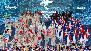 The delegations of Canada and France enter the stadium during the closing ceremony of the 2022 Winter Olympic Games, Feb. 20, 2022.