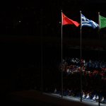 The flags of China, Greece and Italy sway in the wind during the closing ceremony of the 2022 Winter Olympic Games, Feb. 20, 2022.