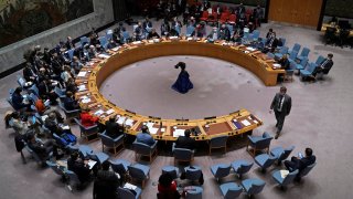 Ukraine Permanent Representative to the United Nations Sergiy Kyslytsya (R) walks to his seat during an emergency meeting of the UN Security Council on Ukraine in New York on February 23, 2022