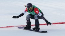 Lindsey Jacobellis of Team United States reacts crossing the finish line to win the gold medal during the Women's Snowboard Cross Big Final on day five of the 2022 Winter Olympics at Genting Snow Park on Feb. 9, 2022, in Zhangjiakou, China.