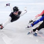 Kristen Santos of Team USA overtakes Petra Jaszapati of Team Hungary and Cynthia Mascitto of Team Italy in the middle of the women's 1000m Heats at the 2022 Winter Olympics, Feb. 9, 2022, in Beijing, China.