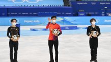 Gold medalist Nathan Chen of Team United States (C), Silver medalist Yuma Kagiyama of Team Japan (L), and Bronze medalist Shoma Uno of Team Japan (R) pose during the Men Single Skating flower ceremony on day six of the Beijing 2022 Winter Olympic Games at Capital Indoor Stadium on February 10, 2022 in Beijing, China.