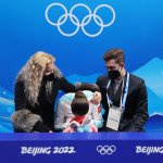 Kamila Valieva of Team ROC reacts to her score with choreographer Daniil Gleikhengau, right, and coach Eteri Tutberidze, left, after the Women's Free Skate event at the 2022 Winter Olympic Games, Feb. 17, 2022, in Beijing.
