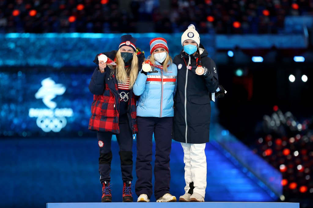 Gold medallist Therese Johaug of Team Norway, center, silver medallist Jessie Diggins of Team United States, left, and bronze medallist Kerttu Niskanen of Team Finlandpose with their medals during the Women's 30km Mass Start medal ceremony at the 2022 Winter Olympics Closing Ceremony, Feb. 20, 2022, in Beijing.