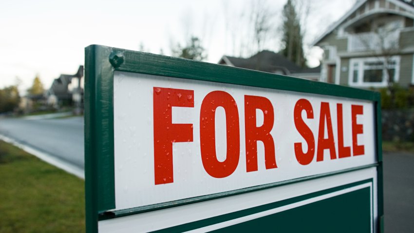 A for sale sign in front of a home. FILE.