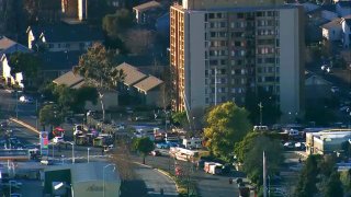 Oakland firefighters at the scene of a fire at a residential tower.