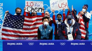 Nathan Chen and teammates await his score