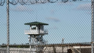 FILE – In this April 16, 2018, photo, a guard tower stands above the Lee Correctional Institution, a maximum security prison in Bishopville, S.C.