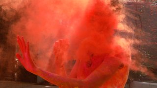 A reveller is covered in colored powder during Holi, the Hindu festival of colors, in Hyderabad, India, Friday, March 18, 2022. Holi also heralds the arrival of spring.