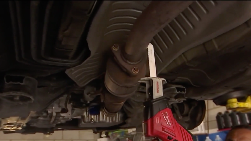 Aziz Hussein of A&A Auto  Performance demonstrates a catalytic converter theft with a saw.