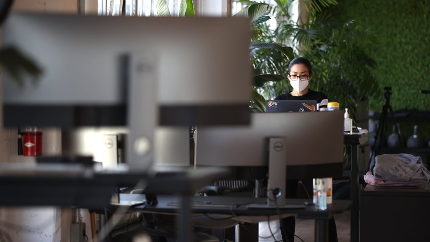 Atsuko Bolinguit, with tech startup company Fast, works in the office at her desk on March 24, 2021 in San Francisco, California.