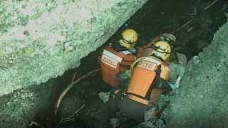 In this photo released by the 1st Regional Japan Coast Guard Headquarters, rescuers attend a person found on a rocky area near the tip of Shiretoko Peninsula in northern Japan of Hokkaido Sunday, April 24, 2022.