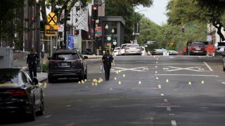 Police officers investigate at the site of a mass shooting in Sacramento, California.