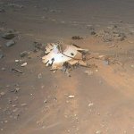 Perseverance’s backshell, supersonic parachute, and associated debris field is seen strewn across the Martian surface in this image captured by NASA’s Ingenuity Mars Helicopter during its 26th flight on April 19, 2022.