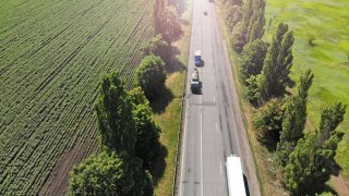 Truck, wagon and car driving on the highway, aerial. Transport logistics background.