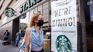 A ‘We’re Hiring!’ sign is posted at a Starbucks in Los Angeles, California.