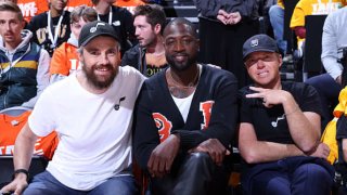 Atlassian Co-CEO Mike Cannon-Brookes poses for a photo with Utah Jazz co-owners, Dwyane Wade and Ryan Smith during Round 1 Game 3 of the NBA Playoffs on April 21, 2022 at vivint.SmartHome Arena in Salt Lake City, Utah.