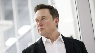 FILE: Elon Musk, CEO of Space Exploration Technologies Corp. (SpaceX) and Tesla Inc., listens as Jim Bridenstine, administrator of NASA, speaks during an event at SpaceX headquarters in Hawthorne, California on Oct. 10, 2019.