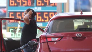 A customer pumps gas into their car at a gas station on May 18, 2022 in Petaluma, California.