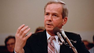 Former National Security Advisor Robert C. McFarlane gestures while testifying before the House-Senate panel investigating the Iran-Contra affair on Capitol Hill in Washington