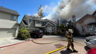 Firefighters at the scene of a house fire in Campbell.