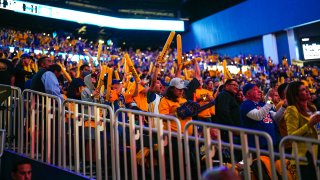 Fans of the Golden State Warriors cheer.