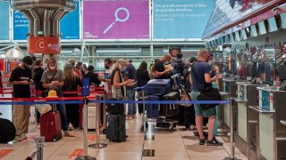 travelers wearing mandatory protective masks