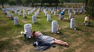 Mary McHugh mourns her slain fiance Sgt. James Regan at "Section 60" of the Arlington National Cemetery.