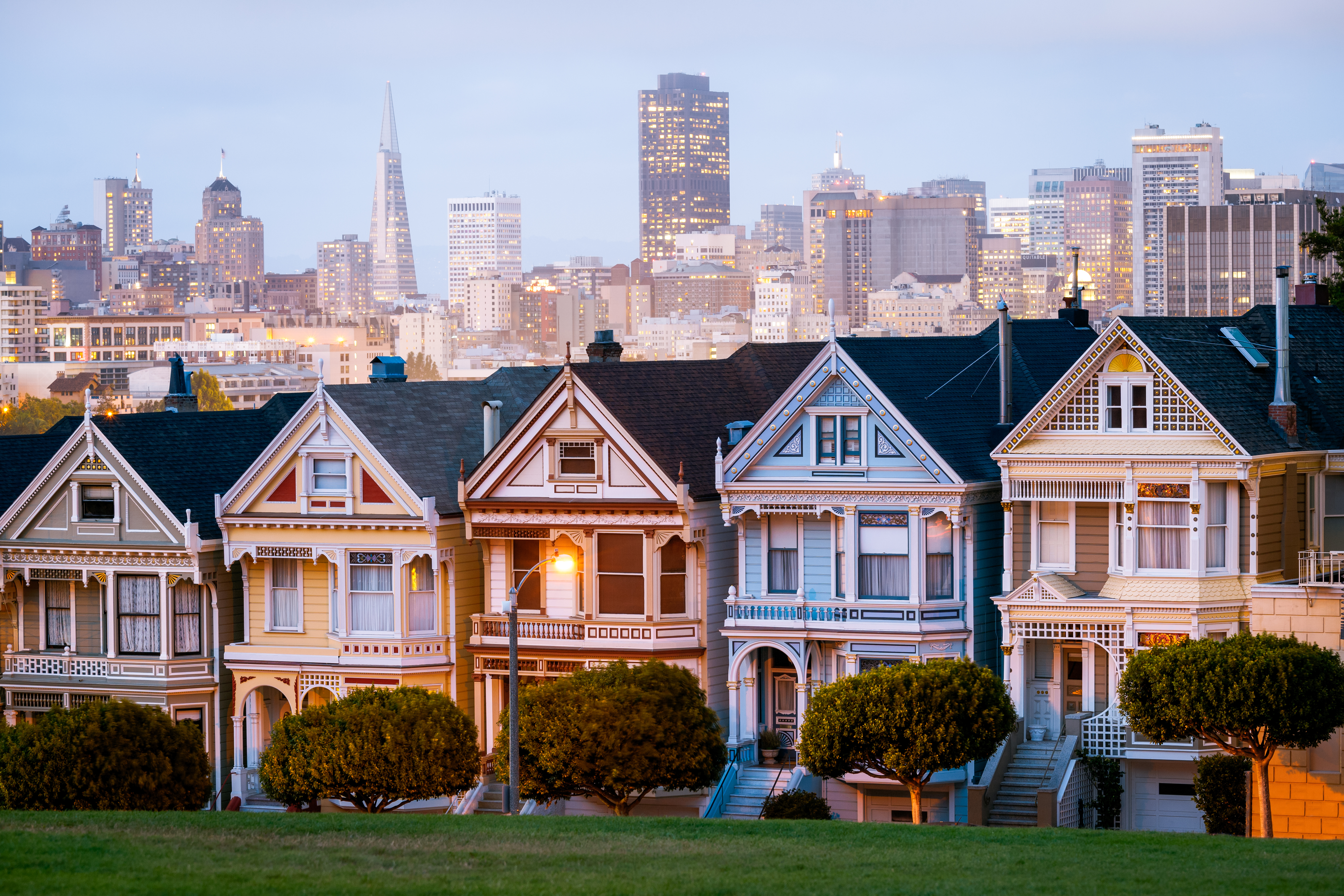 The iconic painted ladies houses with San Francisco downtown skyline in the distance