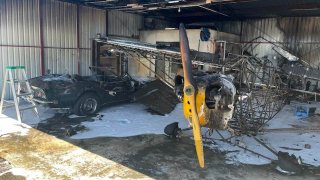 A small plane and a classic Corvette after a fire in a hangar at the Petaluma Airport.