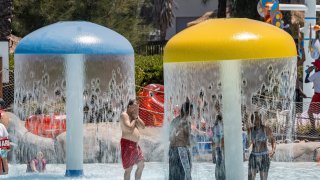 People cool off at Six Flags Hurricane Harbor water park in Concord, California, U.S., on Thursday, June 17, 2021.