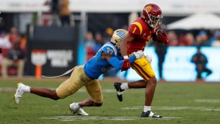 USC Trojans wide receiver Gary Bryant Jr. (1) catches the ball and gets tackled by UCLA Bruins defensive back Quentin Lake (37) during a college football game between the UCLA Bruins and the USC Trojans on November 20, 2021, at United Airlines Field at The Los Angeles Memorial Coliseum in Los Angeles, CA. (Photo by Jordon Kelly/Icon Sportswire via Getty Images)