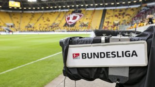 A "Bundesliga" sign hangs from a television camera in the Rudolf Harbig Stadium on 24 May, 2022, in Saxony, Dresden.