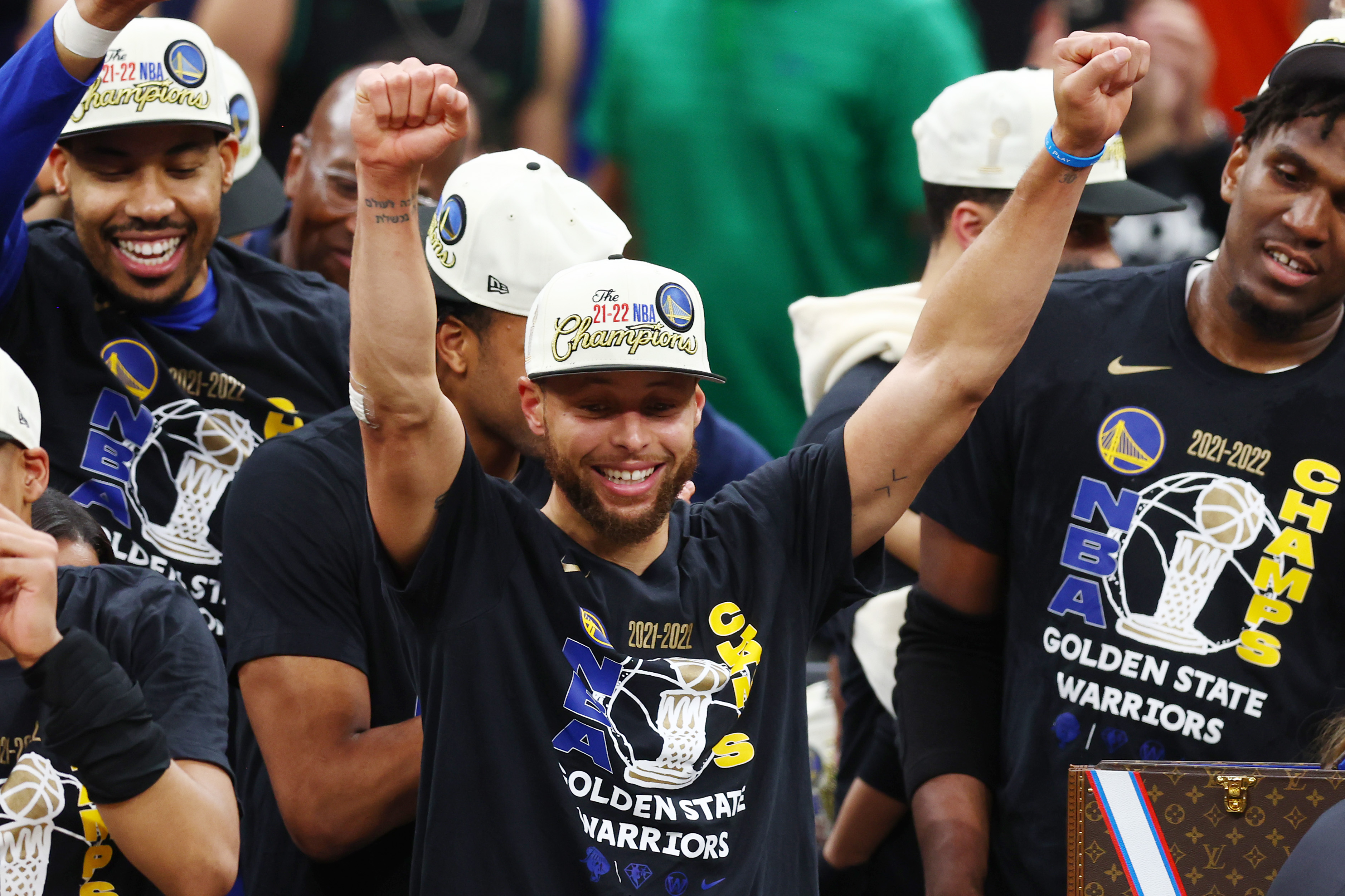 Golden State Warriors' Stephen Curry gestures while holding the Larry O'Brien  trophy during a parade and rally after winning the NBA basketball  championship, in Oakland, Calif. (AP Photo/Marcio Jo …
