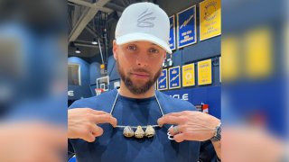 Stephen Curry shares a photo of himself wearing a necklace with his NBA championship rings.