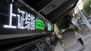 A LED screen displays the numbers for the Shanghai and Shenzhen stock indexes is seen on July 06, 2022 in Shanghai, China. (Photo by Hugo Hu/Getty Images)
