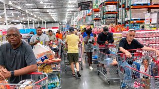 Shoppers wait in a check-out line at a Costco wholesale store in Orlando, Florida.