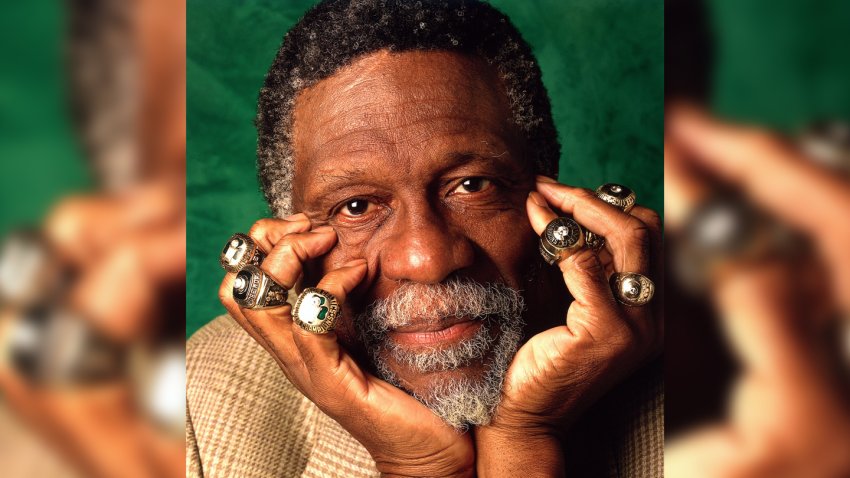 Bill Russell poses for a photo with his 11 championship rings in 1996 in Boston.