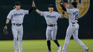 OAKLAND, CALIFORNIA – AUGUST 23: (L-R) JJ Bleday #67, Jacob Stallings #58 and Brian Anderson #15 of the Miami Marlins celebrates defeating the Oakland Athletics 5-3 at RingCentral Coliseum on August 23, 2022 in Oakland, California. (Photo by Thearon W. Henderson/Getty Images)