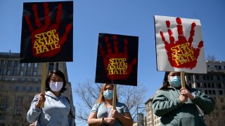 People rally to protest recent violence against people of Asian descent at McPherson Square near the White House in Washington, March 21, 2021.