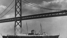 Queen Elizabeth II of Great Britain visits San Francisco. Her majesty's Yacht Britannia is going under the Bay Bridge to Pier 50 to dock, March 4, 1983.