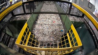 Ground up plastics that Alterra Energy receives from recycling facilities, move along a conveyor at the start of their process that transforms the material into a liquid that is then used in the manufacture of plastic, from the facility in Akron, Ohio on Thursday, Sept. 8, 2022.