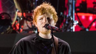 Ed Sheeran performs on-stage.
