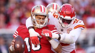 Frank Clark #55 of the Kansas City Chiefs tackles Jimmy Garoppolo #10.